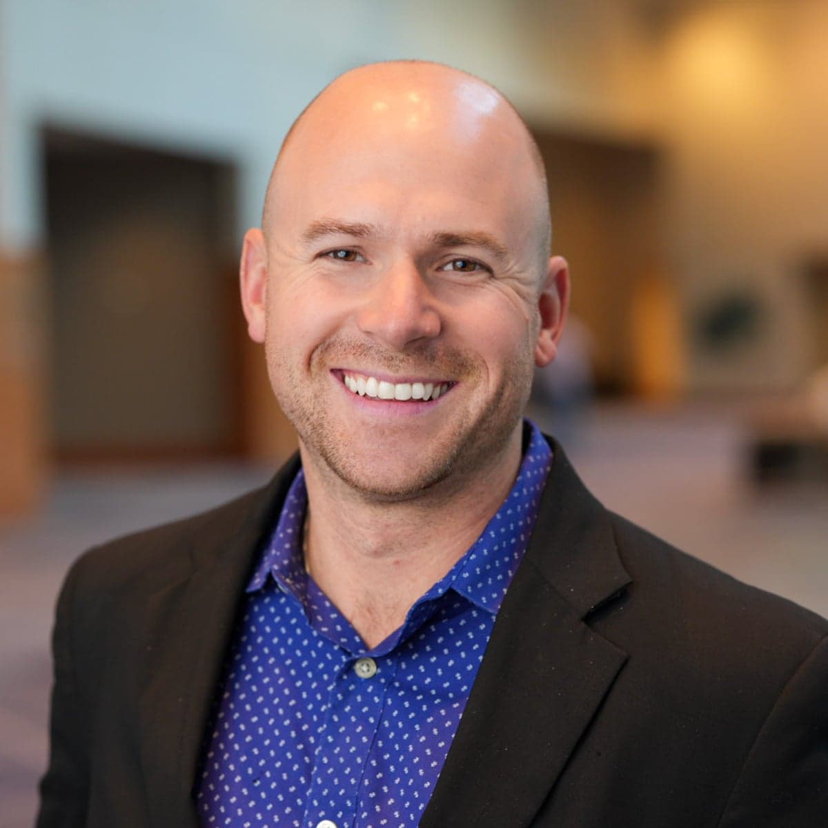 Brendan MacDougall smiling, square portrait.