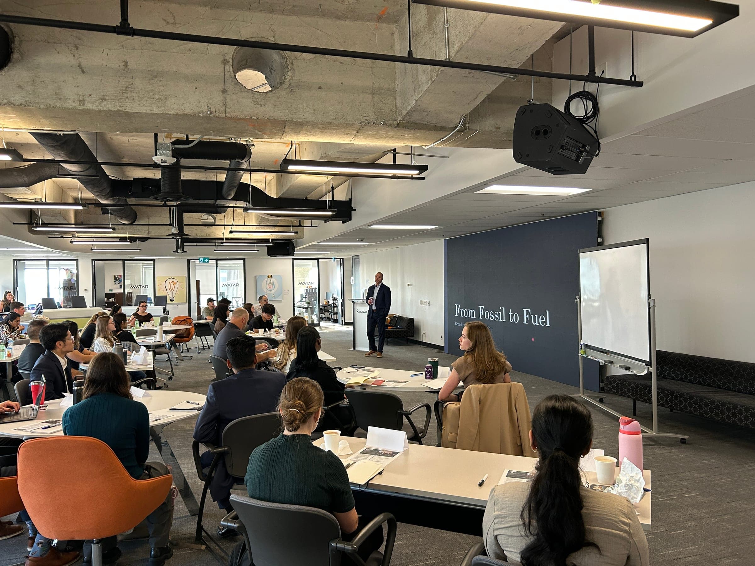 Brendan MacDougall teaching a full, engaged classroom during a From Fossil to Fuel course session.